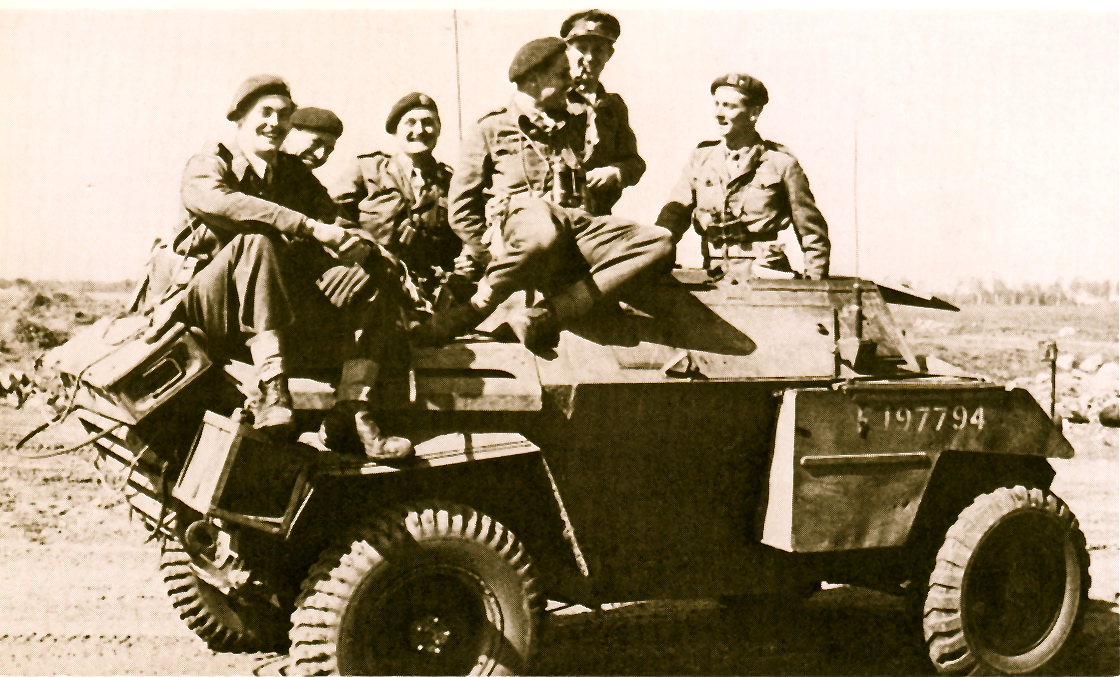 Bill Rathdonnell and his fellow B-Squadron Officers of the Hussars on a Humber scout car
in Germany. L-R: Lieutenant S.R.M. Frazer, Captain Sutherland, Lieutenant R.F. (?),
Captain the Earl of Harrington, Major the Lord Rathdonnell, MC (puffing a pipe at the back) and Captain Weatherby, MC.
