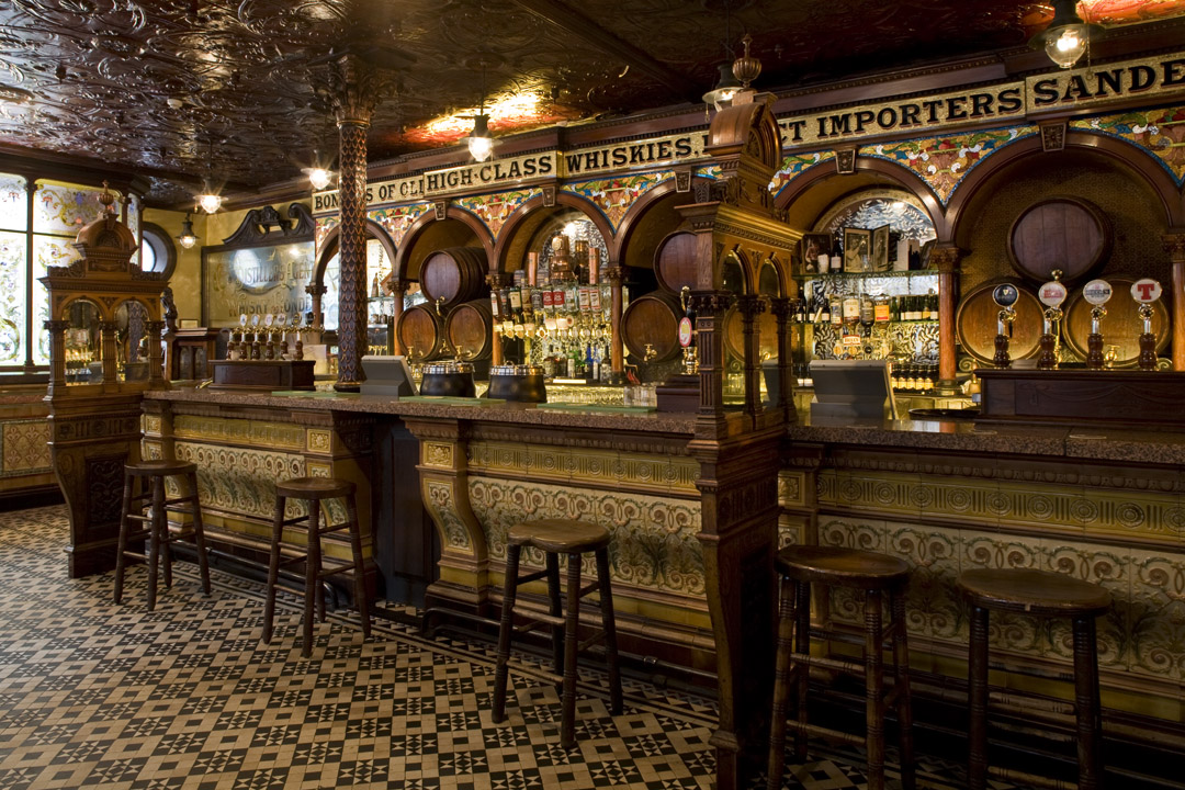A long ‘Alter’ bar of Balmoral red granite is divided by columns and faced with merry tiles and a heated foot rest. Look out for the huge casks with their polished brass taps.