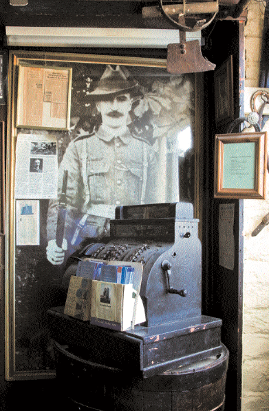 A full-length photograph of The Rahilly, the 1916 rebel leader, hangs behind an old National cash till. Photo: James Fennell.