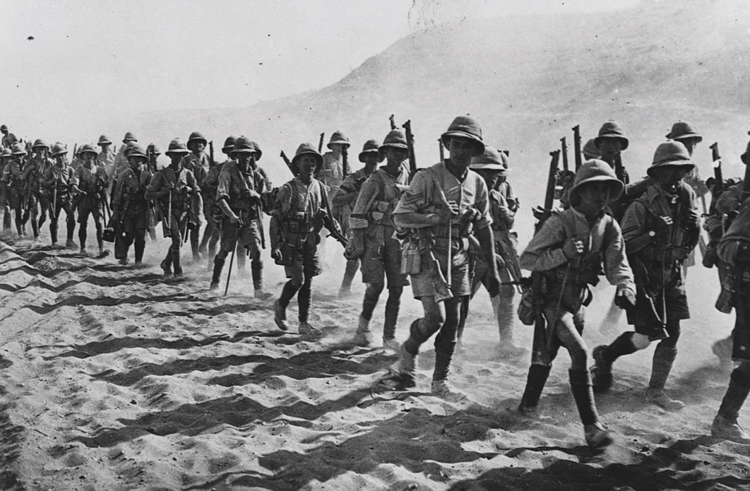British soldiers trudges through the dust, passing over the Jebel Hamarin, during the Mesopotamian campaign.