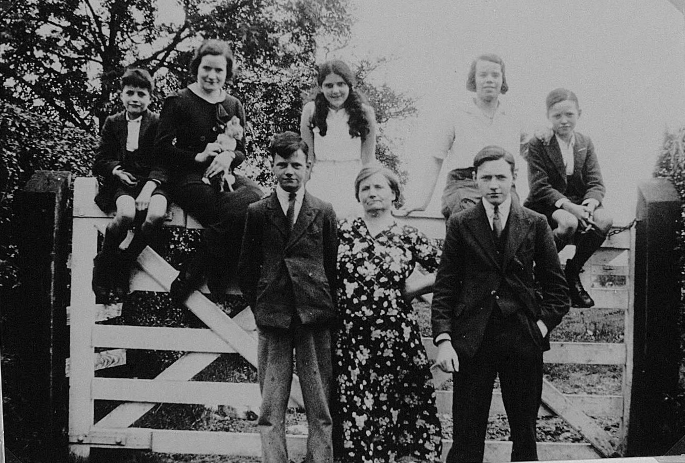 The Halligan Family, 1935, perhaps just before Molly and Jack Shaw's wedding. Jim is on the left sitting on the gate. Joe is on the right. Andy is on the left standing and Tom is on the right. This may include the Woods sisters as well as Molly. Courtesy of Paul Cran.
